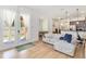 Bright open-concept living room and kitchen with light wood floors and access to a patio at 12255 Joshua Tree Trl, Windermere, FL 34786