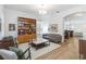 Bright living room with hardwood floors, a bookshelf, neutral colors, and an open floor plan at 12255 Joshua Tree Trl, Windermere, FL 34786