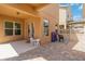 Covered patio featuring a small table set for , brick pavement and house windows at 12255 Joshua Tree Trl, Windermere, FL 34786