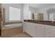 A clean bathroom with a soaking tub, separate glass shower, and vanity with a large mirror at 12884 Penshurst Ln, Windermere, FL 34786