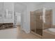 A modern bathroom featuring a glass shower, a soaking tub, a stylish sink with vanity, and a tiled floor at 12884 Penshurst Ln, Windermere, FL 34786