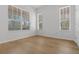 Bright bedroom featuring hardwood flooring and lots of natural light from the large windows at 12884 Penshurst Ln, Windermere, FL 34786