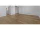 A bright bedroom featuring wood floors, white walls, and multiple doors and closets at 12884 Penshurst Ln, Windermere, FL 34786