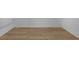 An empty room featuring wood floors and white baseboards with neutral white walls at 12884 Penshurst Ln, Windermere, FL 34786