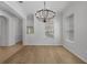 Elegant dining room features hardwood flooring, a modern chandelier, and lots of natural light at 12884 Penshurst Ln, Windermere, FL 34786