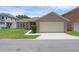 Exterior of a well maintained home with a two car garage and green lawn at 12884 Penshurst Ln, Windermere, FL 34786