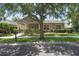 Charming home featuring a landscaped front yard, mature trees, and appealing curb appeal at 12884 Penshurst Ln, Windermere, FL 34786