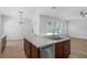 Kitchen island featuring stainless steel appliances, a drop-in sink, and an open view of the living spaces at 12884 Penshurst Ln, Windermere, FL 34786