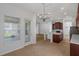 Bright kitchen and breakfast nook with stainless appliances, white counters, and a view of the backyard at 12884 Penshurst Ln, Windermere, FL 34786