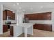 Well-equipped kitchen with an island, stainless appliances, custom cabinetry, and tiled floor at 12884 Penshurst Ln, Windermere, FL 34786