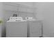 Laundry room featuring a washer and dryer with overhead wire shelving at 12884 Penshurst Ln, Windermere, FL 34786