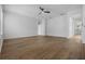 Bright and spacious living area featuring hardwood floors, modern ceiling fan, and views through archways at 12884 Penshurst Ln, Windermere, FL 34786