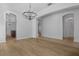 Spacious and light-filled living room with hardwood flooring and archways at 12884 Penshurst Ln, Windermere, FL 34786