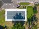 Aerial view of backyard with a tennis/basketball court, putting green, and manicured lawn at 13025 Lake Roper Ct, Windermere, FL 34786