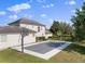 View of the backyard showcasing tennis/basketball court, putting green, and home exterior at 13025 Lake Roper Ct, Windermere, FL 34786