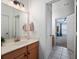 Bright bathroom with white cabinets, tile floor, and modern fixtures at 13025 Lake Roper Ct, Windermere, FL 34786