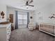 Cozy Bedroom with soft gray carpet, white furniture, and blue curtains at 13025 Lake Roper Ct, Windermere, FL 34786