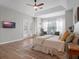 Cozy bedroom featuring a ceiling fan, large windows, and natural light for a relaxing ambiance at 13025 Lake Roper Ct, Windermere, FL 34786
