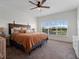 Spacious bedroom with a large bed, plush carpet, and natural light at 13025 Lake Roper Ct, Windermere, FL 34786