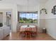 Dining room features a round table, chairs, large windows, and a view of the well-manicured lawn at 13025 Lake Roper Ct, Windermere, FL 34786