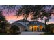 Elegant home with an arched entryway and a well-maintained front lawn at 13025 Lake Roper Ct, Windermere, FL 34786