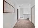 Upstairs hallway with neutral carpet and white walls at 13025 Lake Roper Ct, Windermere, FL 34786