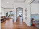 Bright hallway featuring hardwood floors leading into the living room and playroom at 13025 Lake Roper Ct, Windermere, FL 34786