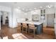 Bright kitchen features shaker cabinets, large island with seating, and hardwood floors at 13025 Lake Roper Ct, Windermere, FL 34786
