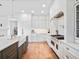 Bright kitchen features shaker cabinets, stainless appliances, and hardwood floors at 13025 Lake Roper Ct, Windermere, FL 34786