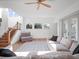 Spacious living room with hardwood floors, a ceiling fan, large windows, and comfortable seating at 13025 Lake Roper Ct, Windermere, FL 34786