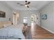 Open main bedroom features a ceiling fan, a view of the doorway, and hardwood floors at 13025 Lake Roper Ct, Windermere, FL 34786