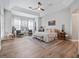 Bright main bedroom features trey ceilings, a ceiling fan, and large windows for natural light at 13025 Lake Roper Ct, Windermere, FL 34786