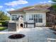 An outdoor kitchen, including a pizza oven, granite counters, and a built-in stainless steel grill at 13025 Lake Roper Ct, Windermere, FL 34786