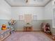Bright playroom featuring a light wood floor, a pink patterned rug, and soft, muted wall colors at 13025 Lake Roper Ct, Windermere, FL 34786