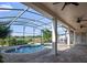 Covered lanai offering views of the screened pool with a spa and fountain, plus a manicured backyard at 13025 Lake Roper Ct, Windermere, FL 34786