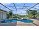 Beautiful screened pool with a spa and fountain, surrounded by lush landscaping and scenic views at 13025 Lake Roper Ct, Windermere, FL 34786