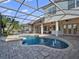 Backyard pool area featuring an inground pool with a spa and water fountains, surrounded by brick pavers at 13025 Lake Roper Ct, Windermere, FL 34786