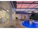 Backyard pool area with a screened enclosure and an inground pool and spa, illuminated by LED lighting at 13025 Lake Roper Ct, Windermere, FL 34786