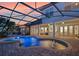 Stunning sunset view of the screened pool with spa, outdoor kitchen, and meticulously maintained backyard at 13025 Lake Roper Ct, Windermere, FL 34786