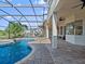Backyard pool area featuring a covered lanai and an inground pool and spa surrounded by a screened enclosure at 13025 Lake Roper Ct, Windermere, FL 34786