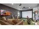 The recreation room boasts a golf simulator, large TV, and comfortable seating at 13025 Lake Roper Ct, Windermere, FL 34786