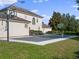 Backyard sport court, including two basketball hoops, set against a house with green grass at 13025 Lake Roper Ct, Windermere, FL 34786