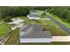 Aerial view of multiple single story homes along a quiet street at 1304 Hillsborough Ct, Kissimmee, FL 34759