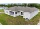 Aerial view of a single story home with a gray roof and a large backyard at 1304 Hillsborough Ct, Kissimmee, FL 34759