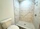 Modern tiled shower with white marble and small patterned floor tiling at 1304 Hillsborough Ct, Kissimmee, FL 34759