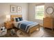 Stylized bedroom featuring a twin bed with blue decor, artwork, and wood furniture, creating a warm space at 1304 Hillsborough Ct, Kissimmee, FL 34759
