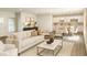An open concept living room, kitchen and dining area are decorated in neutral colors and modern furnishings at 1304 Hillsborough Ct, Kissimmee, FL 34759