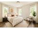 A bedroom features neutral-toned decor, soft lighting, and windows with views of the surrounding greenery at 1304 Hillsborough Ct, Kissimmee, FL 34759