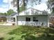 View of the home's backyard, featuring a patio and lush green grass at 1361 Sterling Oaks Dr, Casselberry, FL 32707