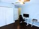 Bedroom featuring a desk and chair, dark wood floors, and a double door closet at 1361 Sterling Oaks Dr, Casselberry, FL 32707